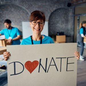 woman holding a donate sign